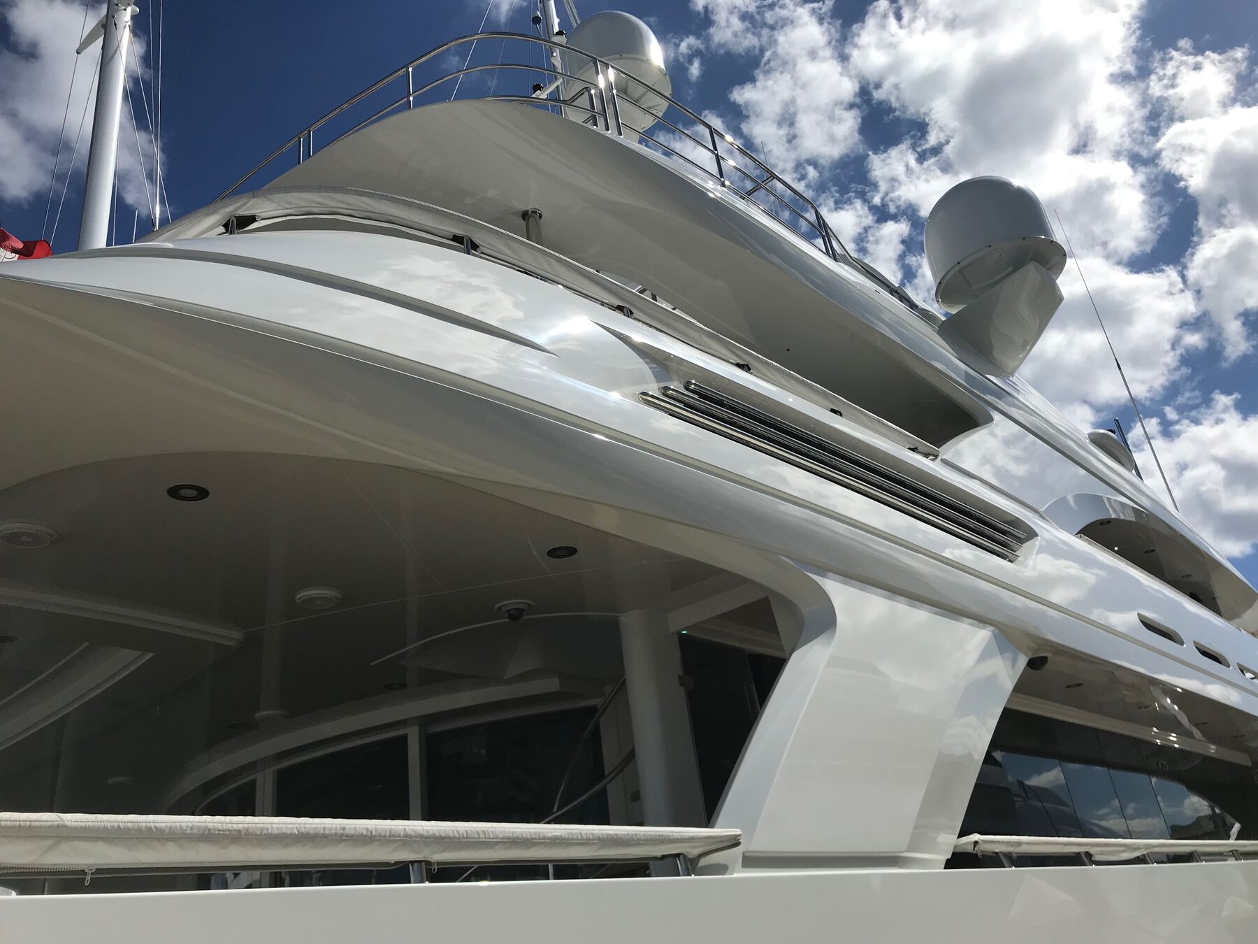 Restored superyacht hull reflecting Florida sky
