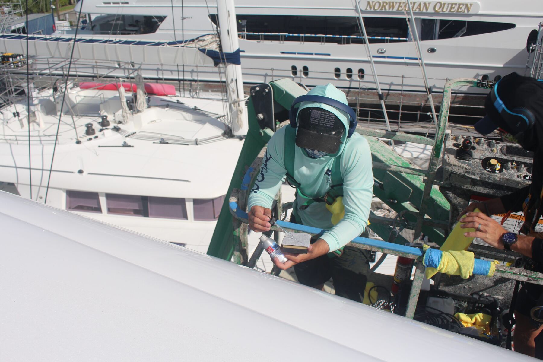Crew member sanding hull